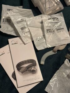 Two CPAP user guides lie next to four unopened felt filter packages.