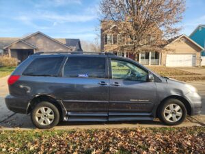 side view of van that appears to be either blue or gray