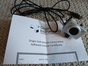 HeadMouse Nano resting on top of software license certificate. Date on certificate is April 22, 2020.