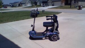 A blue scooter parked on a drive way