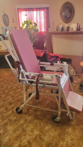 side view of a stretcher that is currently in the formation of a chair