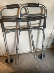 gray walker folded up leaning against a wall