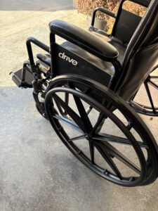 side view of black, manual wheelchair showing the brand 