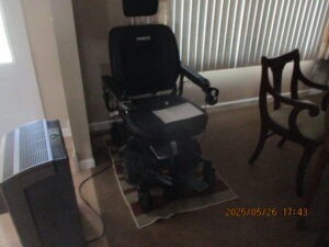 side angled view of black electric wheelchair