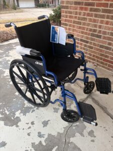 manual wheelchair with foot rests and handles to push