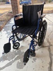 manual wheelchair with foot rests and handles to push
