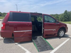 red van showing sliding door open on passenger side with a ramp