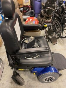 side view of a power scooter seat with arm rests, a foot platform, and blue finish on the bottom of the scooter
