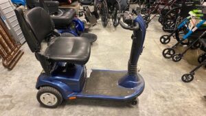 side view of a black and blue power scooter with a seat, a foot platform, and steering handles connected to a pivotable post