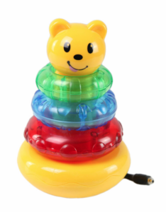 Yellow ring-stacker toy with a cute bear head at the top. Three thick rings are stacked on the toy. One ring is green, one is blue, and the third is red.