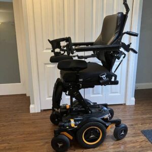 side view of a power wheelchair, showing how high the seat can raise up