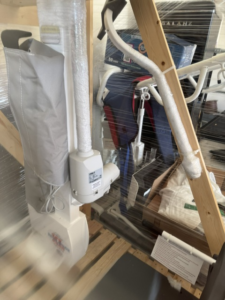 Close up of pool lift in crate, viewed from a side angle.