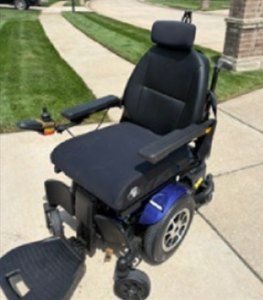 Slightly blurry three-quarter view of power chair.