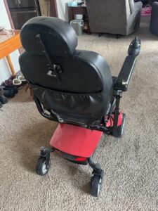 Back of power wheelchair. There is a large storage pocket on the back of the chair.