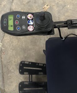 Close up of wheelchair’s control panel and joystick.