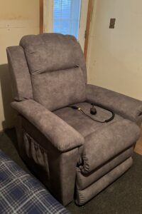Side of recliner. A storage pocket is visible on the side of the chair.