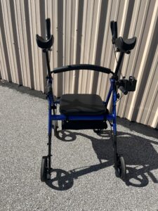 Front of walker. Base is dark blue with a black cushion and black arm supports. Like new condition.
