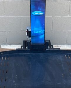 black platform with a vertical bar that reads