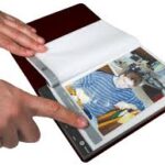 Book containing picture with person pressing button at the button of the page containing a picture