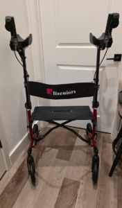 Front view of black and red Aliseniors walker. Includes a seat, back rest, and hand rests. Like new condition.