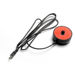 Circular black switch with red face. Connected to a cord with a jack plug.